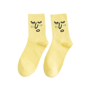 Bright yellow cotton crew socks featuring quirky cartoon face embroidery and minimalist art