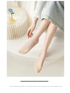 Close-up of seamless beige no-show socks with cute cartoon embroidery for summer
