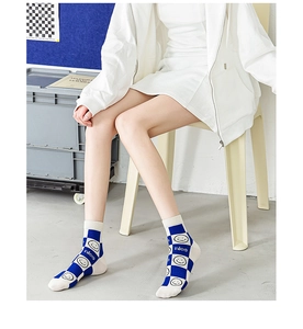 Close-up of blue checkerboard socks with smiley face pattern and nice text detail