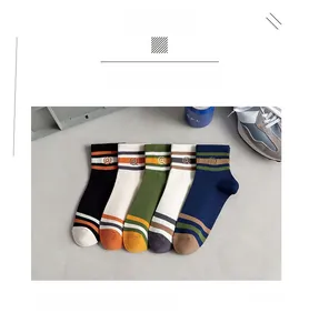 Close-up of five pairs of cotton socks featuring contrast stripes and embroidered logos