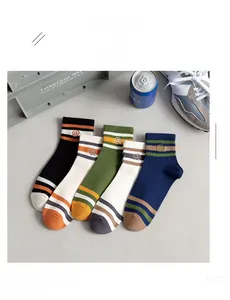 Detailed view of striped cotton crew socks with embroidered logos in a multi-color set