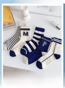 Detail of five-pair navy blue and off-white crew socks set with striped jacquard patterns