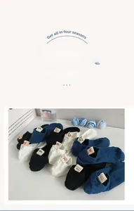 Detail of low-cut cotton socks featuring cute bear and heart embroidered heel tags