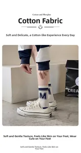 Detail of white cotton athletic socks with blue stripes and M logo with canvas shoes
