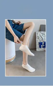 Detail of white cotton low-cut boat sock featuring heel anti-slip label design