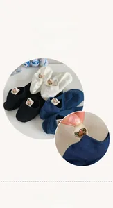 Detail of cotton low cut socks with small duck woven label on the heel in various colors