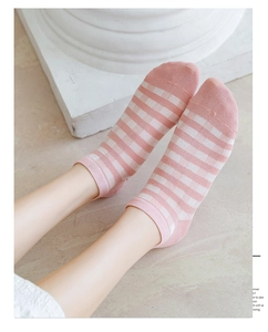 Detail of pink and white checkered cotton low-cut ankle socks on model for casual wear