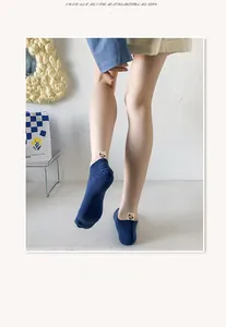 Detailed view of deep blue invisible cotton socks featuring a cute bear heel label