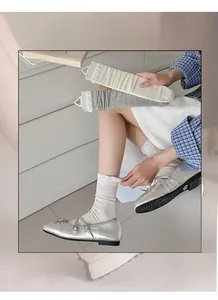 Detail of sweet ballet-style socks with lace trim and ribbed texture for women