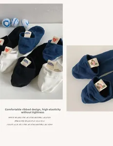 Close-up of elastic cuffs on cotton ankle socks with diverse cartoon decorative labels