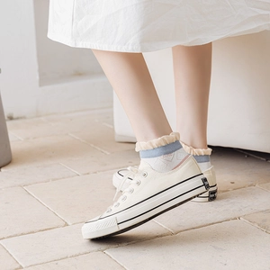 Low-top beige canvas sneakers paired with sweet ruffled trim plaid ankle socks