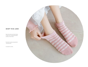 Detail shot of pink and white striped low cut cotton socks for women in a round frame