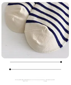 Detailed close-up of smooth toe seam and blue striped cotton knit fabric texture