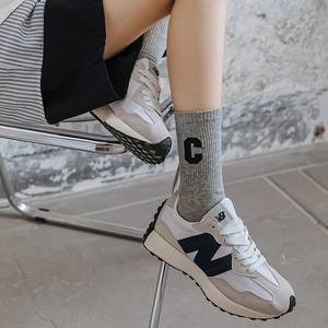 Cotton mid-calf socks with C-letter embroidery paired with retro sneakers on feet