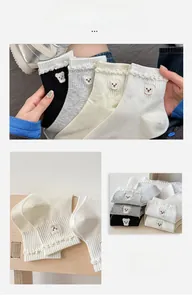 Detail of cute bear embroidery and ruffle trim on pastel cotton short socks for women