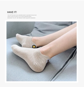 Detail of light beige cotton low-cut ankle socks with cute cartoon bear patches