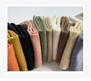 Detailed view of ten colorful cotton low cut socks with vertical ribbed knit texture
