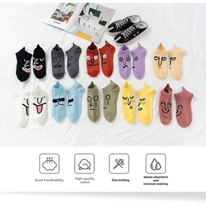 Flat lay close-up of colorful cotton ankle socks featuring assorted cartoon facial expressions