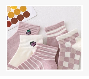 Detail of lavender cotton socks with striped, checkered, and grape embroidery patterns
