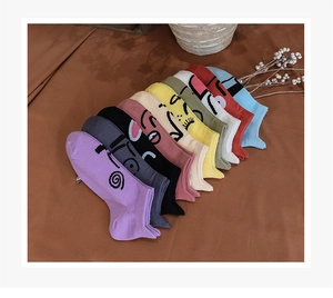 Flat lay of colorful low-cut cotton socks with quirky minimalist cartoon facial expressions
