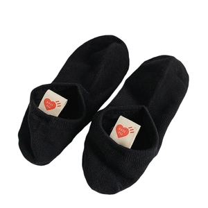 Black cotton blend low-cut boat socks featuring a signature red heart logo on the heel