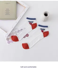 Detail of sheer cat socks with blue stripes and a small red 3D heart embroidery