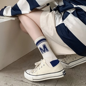 Off-white crew socks with navy stripes and M letter logo for sporty casual street style
