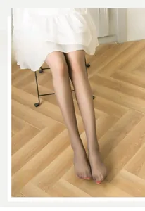 Detail of sheer nude velvet tights showing breathable and high elastic fabric texture