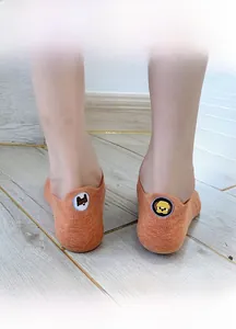 Close-up of orange cotton boat sock featuring a cute dog embroidery on the heel