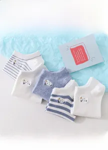 Close-up of low cut socks with sheep embroidery in white and blue cotton fabric
