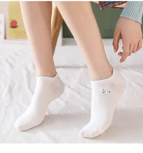 Close-up of white cotton low-cut socks featuring a cute sheep embroidery on the side