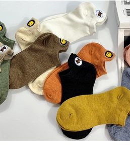Detail view of colorful cotton low cut ankle socks with cute animal embroidery on the heel