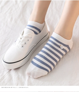 Detail of blue and white striped ankle sock with cute lamb embroidery and sneakers