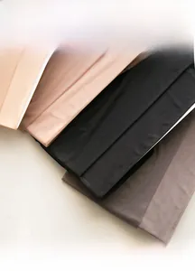 Close-up of soft velvet pantyhose fabric in beige, black, and grey showing high elasticity