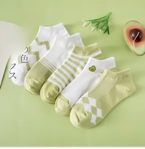 Detail of five pairs of avocado green low cut socks with various patterns and textures
