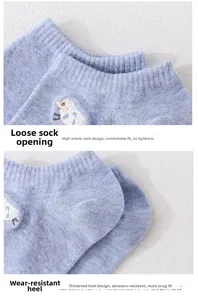 Detail of light blue knit socks featuring sheep embroidery and reinforced thick heels