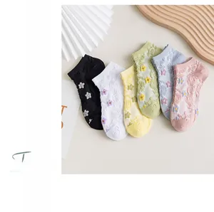 Detailed close-up of six pairs of floral mesh socks in pastel colors with 3D flower patterns