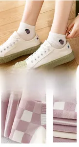 Close-up of purple grape embroidery and soft ribbed knit texture on cotton socks