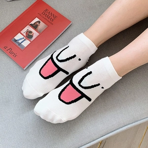 White cotton low cut socks featuring a cute cartoon smiley face with pink tongue details
