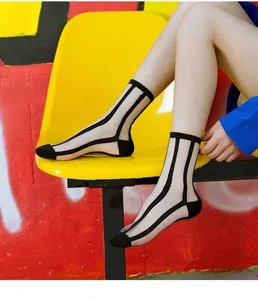 Detail of sheer striped crew socks with reinforced black cotton toes and minimalist design