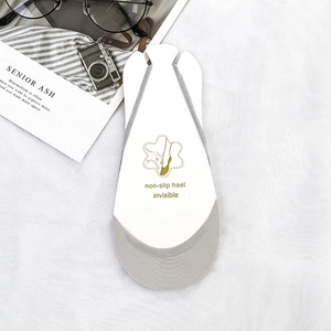 Light grey invisible socks with non-slip heel on white cardboard display insert