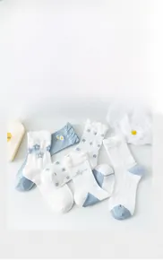 Detail of floral mid-calf cotton socks with daisy embroidery and wavy ruffled cuffs