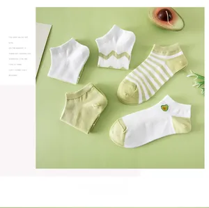Detailed flat lay of avocado green cotton ankle socks with embroidery and wave patterns