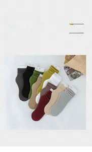Close-up of ten candy-colored cotton socks with vertical stripes and high-quality texture