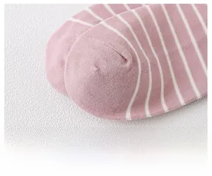 Detailed macro shot of flat toe seam and pink striped cotton knit texture on socks