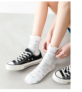 Detail of white cotton mid-calf socks with blue floral print and lace trim for women