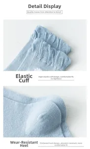 Detail of light blue cotton socks showing ribbed elastic cuffs and reinforced heels