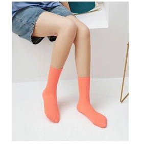 Detail of bright coral ribbed crew socks showcasing soft velvet texture and elasticity