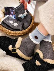 Detailed knit texture of grey wool crew socks with cute puppy embroidery and ribbed cuffs