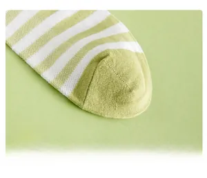 Detail view of smooth toe seam and green striped pattern on cotton blend socks